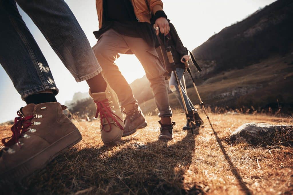Hiking man and woman with trekking boots on the trail